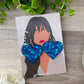 Photograph of one pair of epoxy resin earrings in royal blue heart shape on timber background