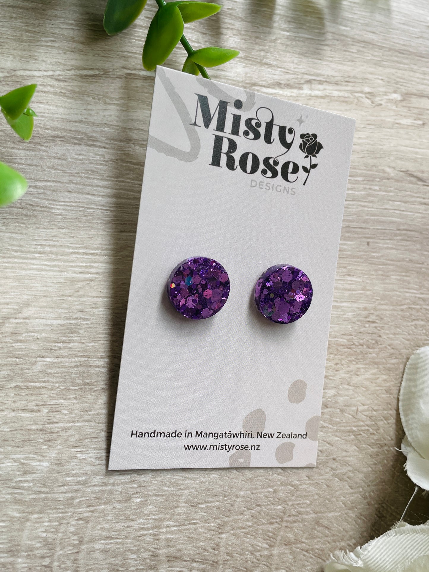 Sparkly circle stud earrings ✨  Mid-purple glitter&nbsp;  These lovely lightweight earrings are sure to add some sparkle to any look!  Approx 1.5cm diameter  Handmade in Waikato, Ne