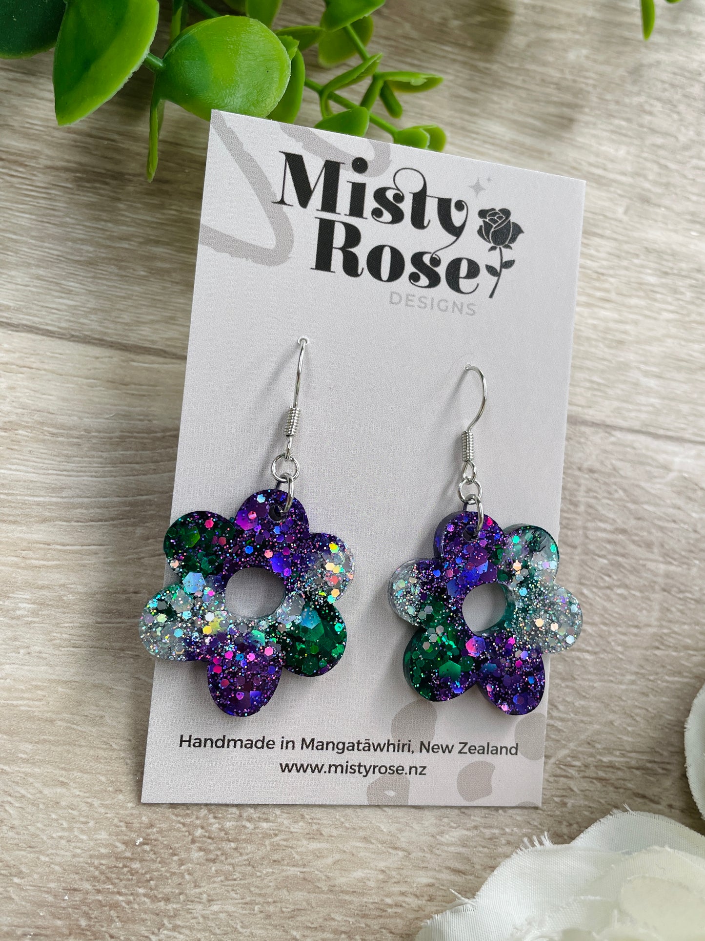 Absolutely stunning medium sized flower earrings!&nbsp;Lovely organic shape 🌸  Mix of emerald green, dark violet purple and silver holographic glitter 💜💚  Approx 2.7cm x 3cm&nbsp;  Lovely &amp; lightweight, these earrings are sure to add some sparkle to any outfit!&nbsp;   Handmade in Waikato, New Zealand - Each pair is a one of a kind find, you will not see anyone else wearing these cuties!&nbsp;