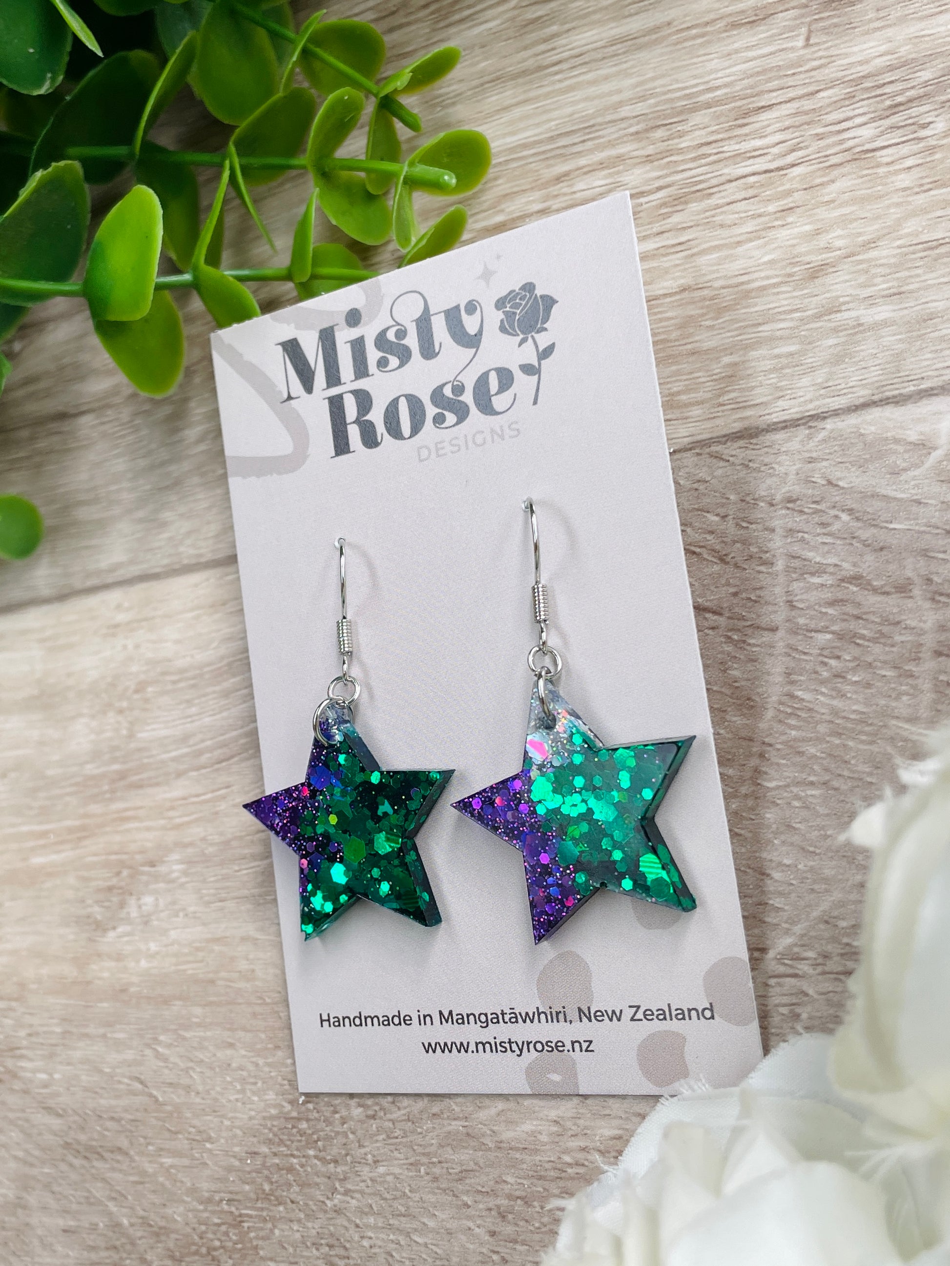 Star earrings ✨&nbsp;  Mix of emerald green, dark violet purple and silver holographic glitter 💜💚  These cute &amp; glittery lightweight earrings are sure to add some sparkle to any look.   Approx 2.5cm x 2.5cm