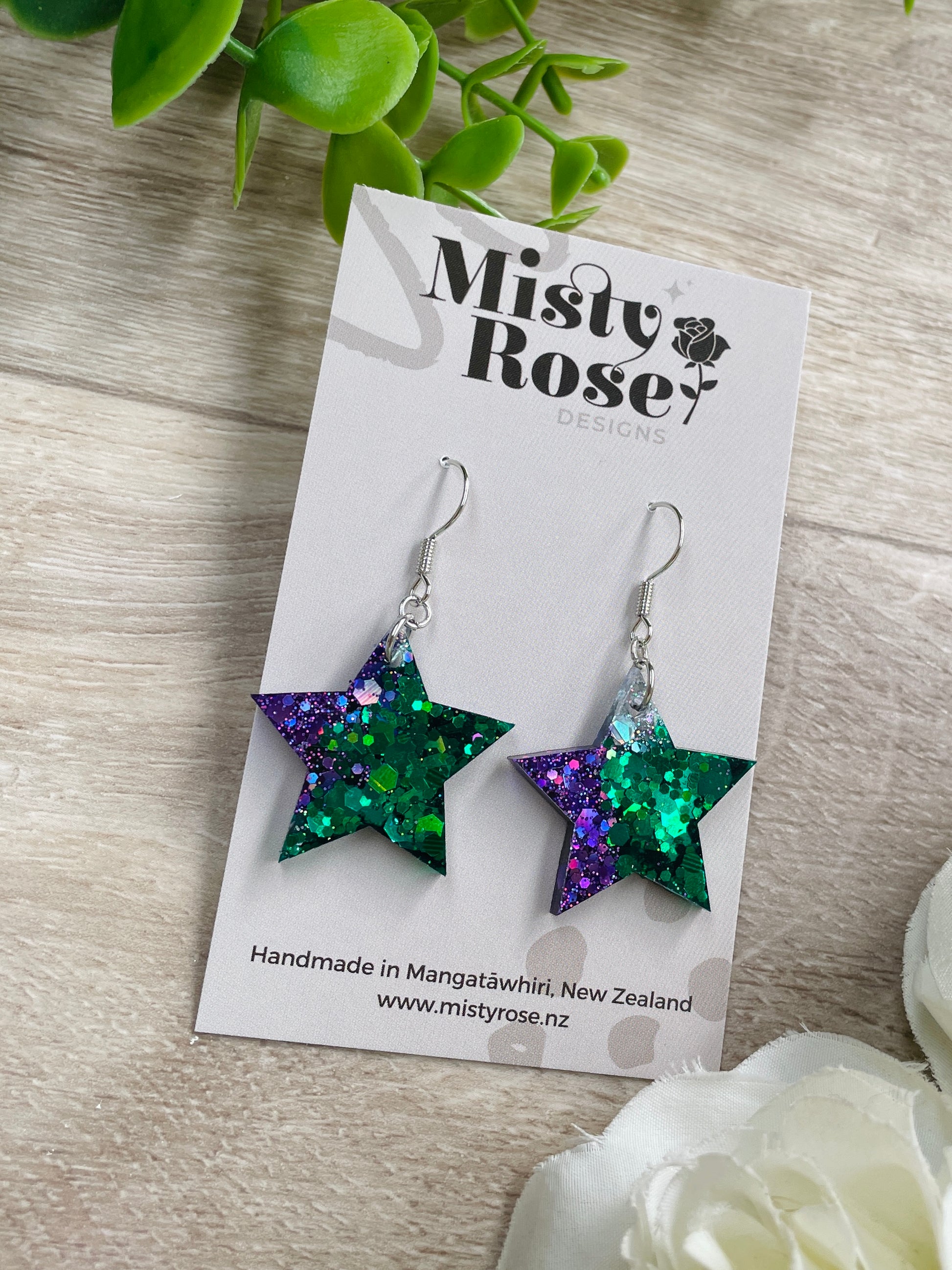 Star earrings ✨&nbsp;  Mix of emerald green, dark violet purple and silver holographic glitter 💜💚  These cute &amp; glittery lightweight earrings are sure to add some sparkle to any look.   Approx 2.5cm x 2.5cm