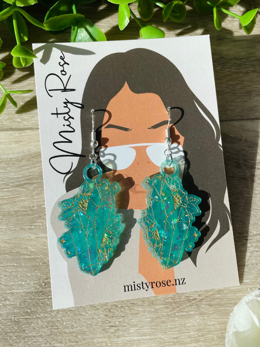 Super cute crystal earrings 💫  Opaque teal / jade with iridescent flakes and light gold etched detailing.  Approx size 4.5cm x 2.3cm  These stunning, lightweight statement earrings are sure to add some magic to any look!  Handmade in Waikato, New Zealand. Each pair is unique, you will not see anyone else wearing these cuties!